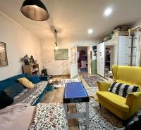 Living room in a family house with colorful furniture and a wooden decor floor.