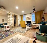 Living room in a family house with a wooden decor floor and various decorations.