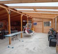 Interior of a family house with wooden construction, furniture, and a clothes drying rack.