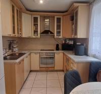 A kitchen in a 2-room apartment with corner cabinets and a spacious countertop.