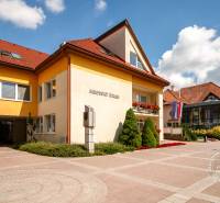The municipal office in Stará Ľubovňa on Popradská Street with a terrace and ornamental shrubs.