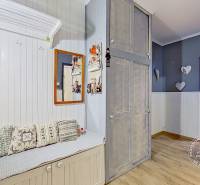 Bright hallway in a 3-room apartment with wooden decor and decorative pillows.