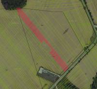 Aerial view of agricultural and forest lands in Ižkovce with marked parcels.