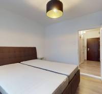 Bedroom in a 2-room apartment with a comfortable bed and a floor with a wooden decor.