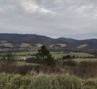 A view from nature near Orovnica with a view of the mountains and a village in the distance.