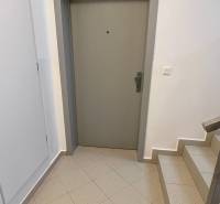 Entrance door of a 2-room apartment with a staircase and tiles.