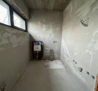 Unfinished bathroom in a family house with a view through the window.