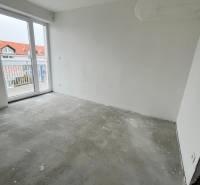 An empty room in a 3-room apartment with access to a balcony, Školská Street.