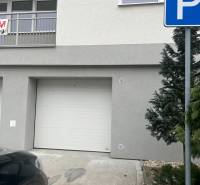 The facade of the building on Školská Street in Chorvátsky Grob with an entrance garage.