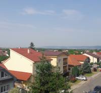 A view of terraced houses with red roofs on Školská Street in Chorvátsky Grob.