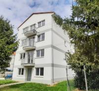 An apartment building on Školská Street in Chorvátsky Grob surrounded by greenery.