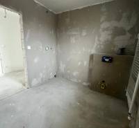 Empty rooms in a 3-room apartment with installation for a bathroom under renovation.