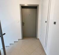 Entrance door with staircase and tiled floor in a 3-room apartment.