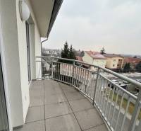 A balcony with a tiled floor and a view of Školská Street in Chorvátsky Grob.