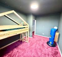 Children's room in a family house with a wooden decor floor and a bunk bed.
