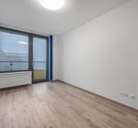 Unfurnished room with a large window and wood-patterned flooring.