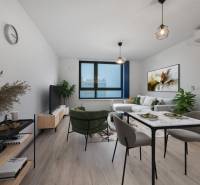 Living room with a sofa and a dining table in a two-room apartment, floor with wooden decor.