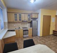 A kitchen in a 3-room apartment with wooden decor and ceramic tiles.