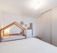 Children's room in a two-room apartment with a children's bed and a wardrobe.