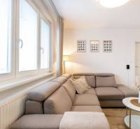 Living room in a two-room apartment with a comfortable sofa and wall decorations.