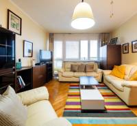 Living room in a 3-room apartment with leather sofas and a wooden decor floor.