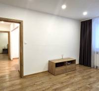 A room in a 3-room apartment with a wooden decor floor, light, and furniture.