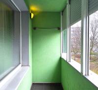 Glazed loggia with tiles in a 3-room apartment. The walls are painted green.
