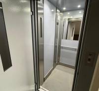 Open elevator with modern interior and metal details in a 4-room apartment.