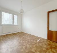 A room with a bright window and a floor with a wooden decor, 4-room apartment.