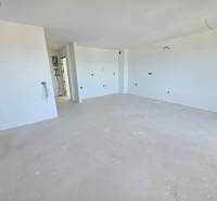 Recreational apartment with clean white walls and spacious floor with wooden decor.