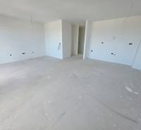 Living space of a holiday apartment with white walls under construction.