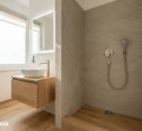Bathroom with a sink and shower in a studio apartment, floor with wooden decor.