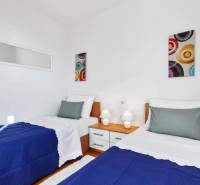 Double room with art on the walls in a 3-room apartment with white walls.