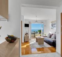 Bright living space in a 3-room apartment with a sea view, wooden decor flooring.