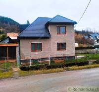 A family house in Jasenica with a new roof and a garden, surrounded by rural landscape.