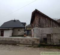 A family house with a wooden extension in Jasenica, surrounded by a fence and a block wall.