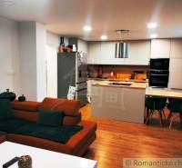 A kitchen with a dining table in a family house, a floor with a wooden decor.