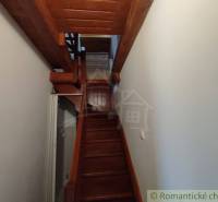 A wooden staircase in a family house leading to the upper floor.