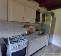 A kitchen in a family house with white cabinets and a gas stove.