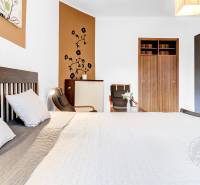 Bedroom in a 2-room apartment with a bed, wardrobe, and wall decoration.