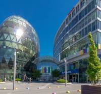 On Vavilovova Street, modern buildings surround a square full of greenery and pedestrians.