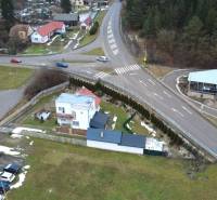 A family house on SNP Street in Považská Bystrica, surrounded by greenery and road infrastructure.