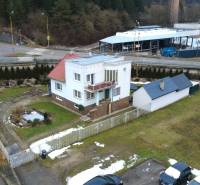 A family house on SNP Street in Považská Bystrica with a landscaped garden and driveway.