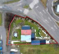 A family house in Považská Bystrica on SNP Street with a landscaped garden and paved land.