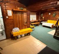 The interior of the cabin with wooden walls and furnishings, comfortable seating, toilet.