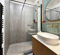 Bathroom on Vajnorská Street, shower corner, gold fittings, large bathtub, suitable for a 2-room apartment.