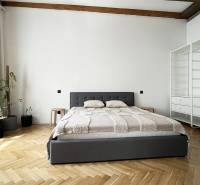 Stylish bedroom with a bed in a 2-room apartment, plants, and storage space on Vajnorská Street.