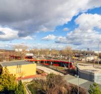 Exterior at Karpatské Square in Bratislava - Rača with trams and industrial buildings.
