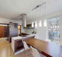 Kitchen in a 4-room apartment with a wood-decor floor and large windows.