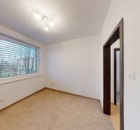A room with a lit lamp and a carpet in a 4-room apartment.